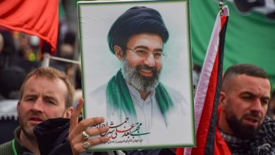 A protester holds up a picture of Mojtaba Khamenei during