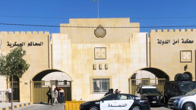 A police vehicle is parked outside a military court in Amman